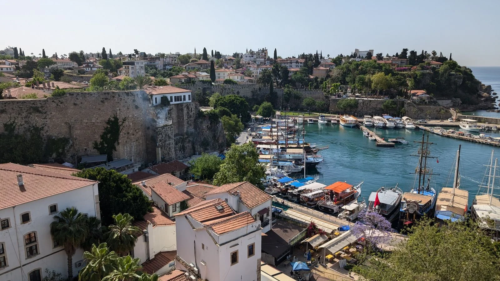 Kaleiçi old harbour and marina below the historic walls and red-tiled roofs in Antalya