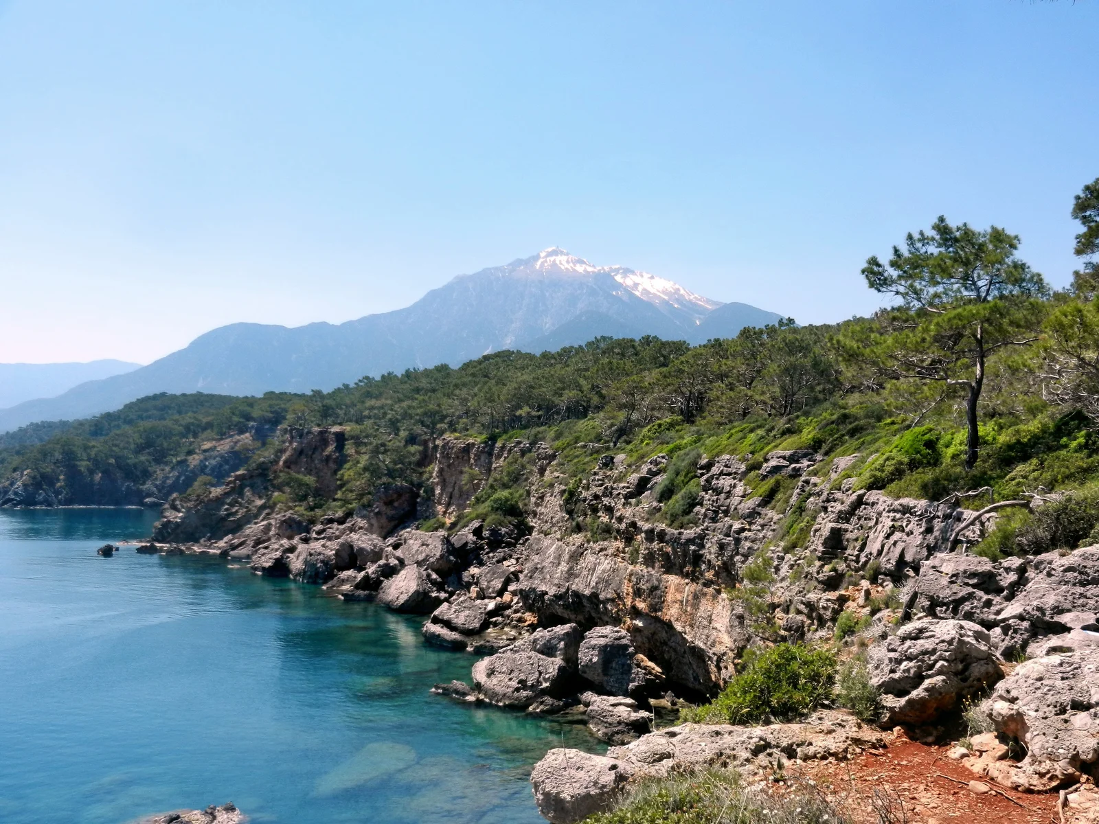 Rocky Mediterranean coast near Çamyuva with Tahtalı Mountain in the background