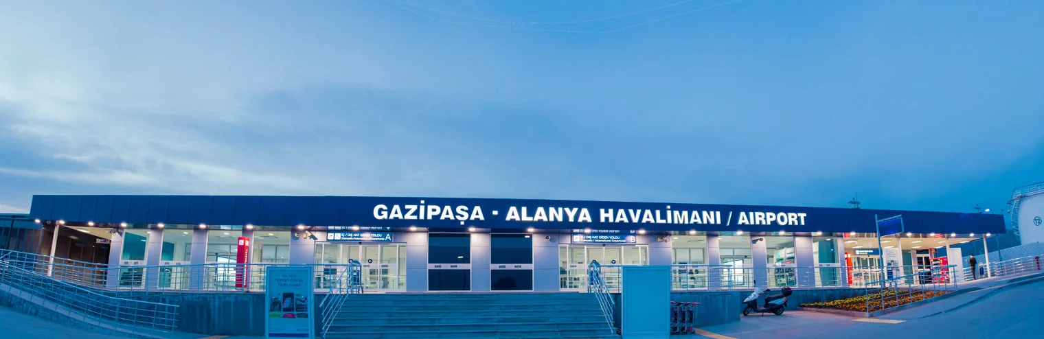 Illuminated terminal entrance at Gazipaşa-Alanya Airport, the closest arrival point to Alanya