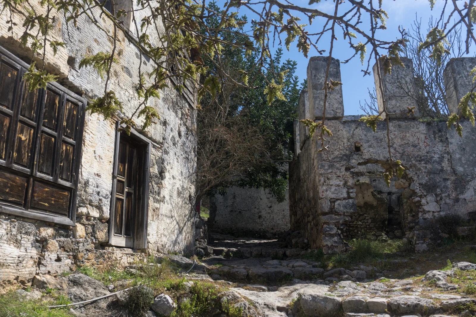 Cobbled lane between abandoned stone houses in Kayaköy