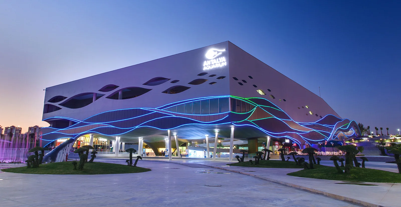Illuminated exterior of Antalya Aquarium in Konyaaltı at dusk