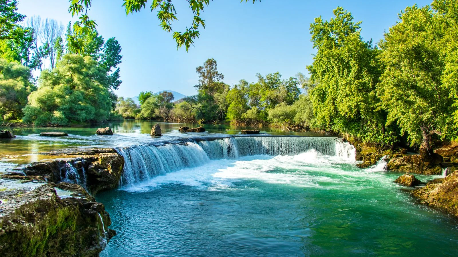 Panoramic view of Manavgat Waterfall surrounded by trees