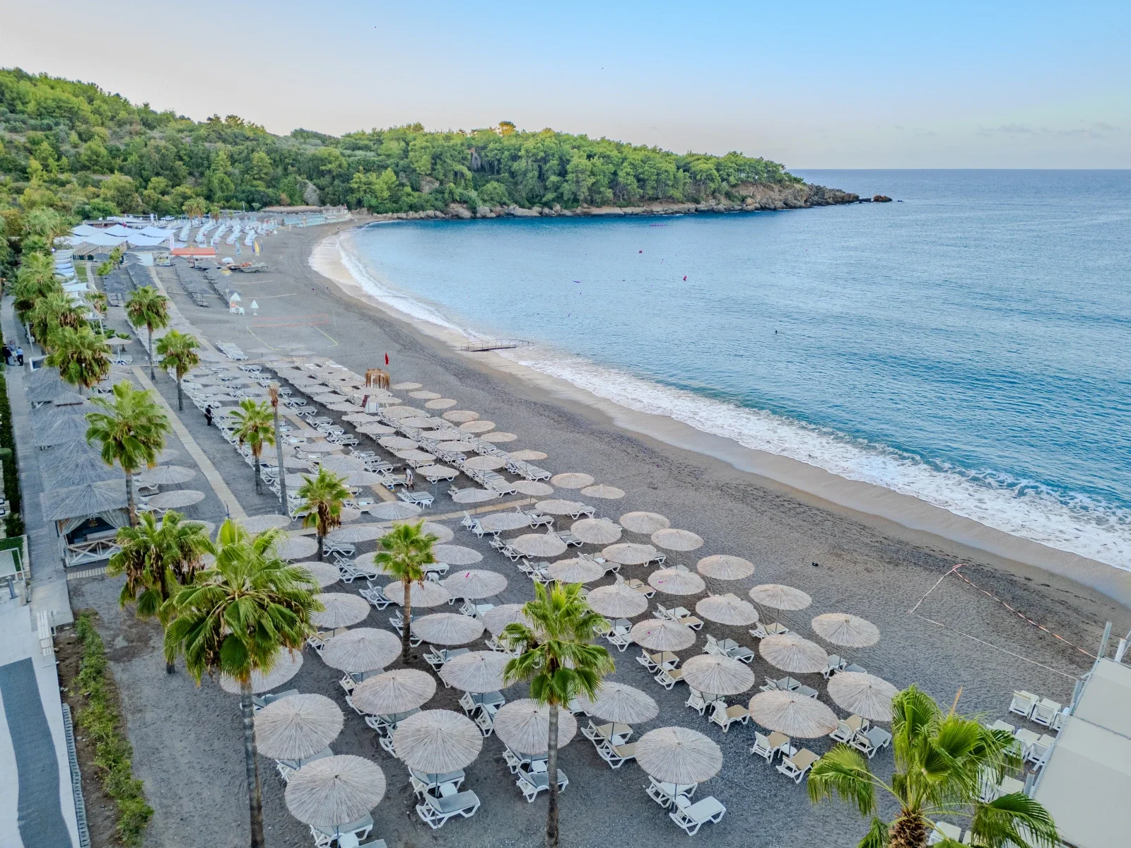 Sand-and-pebble cove at Justiniano Deluxe Resort on the Okurcalar coast