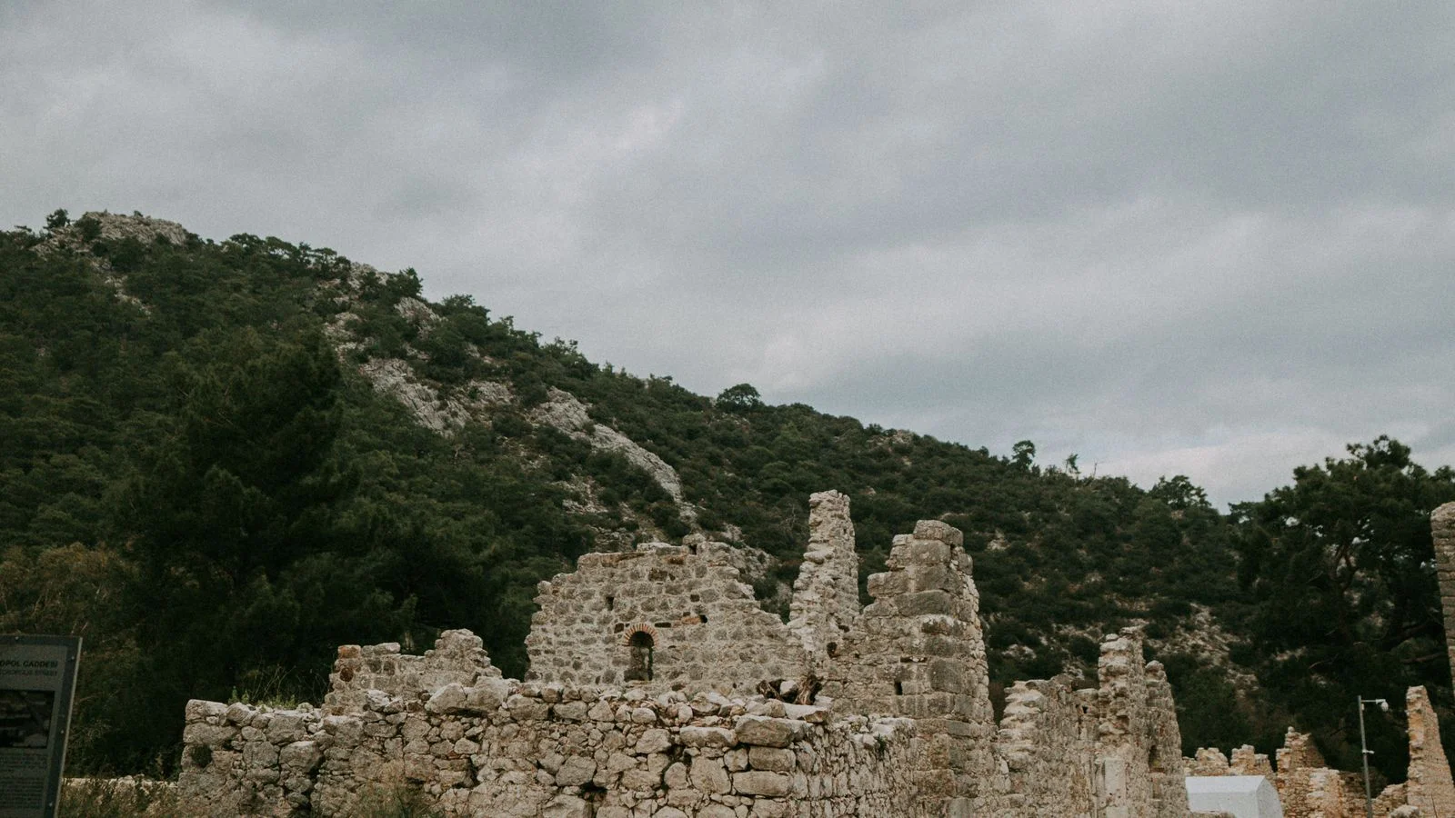 Ancient city ruins of Olympos surrounded by forest