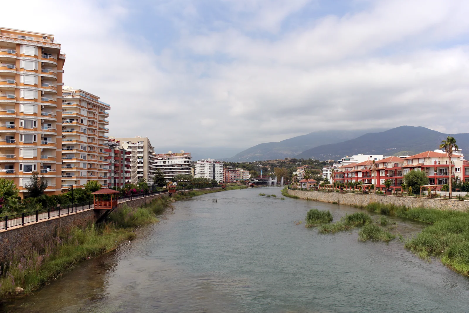Dim River beside Tosmur homes with the Taurus Mountains beyond
